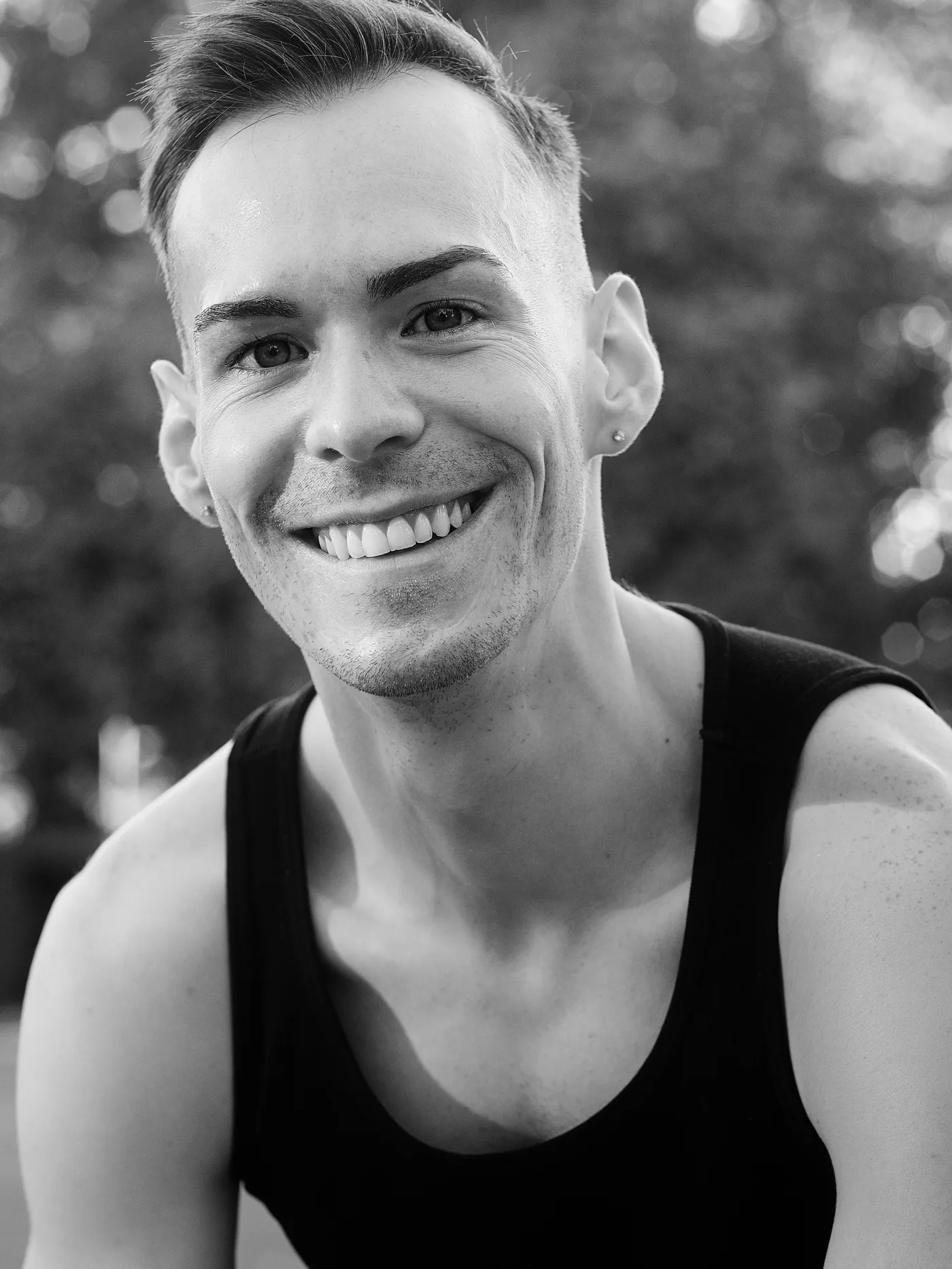 István smiling in a black and white studio portrait