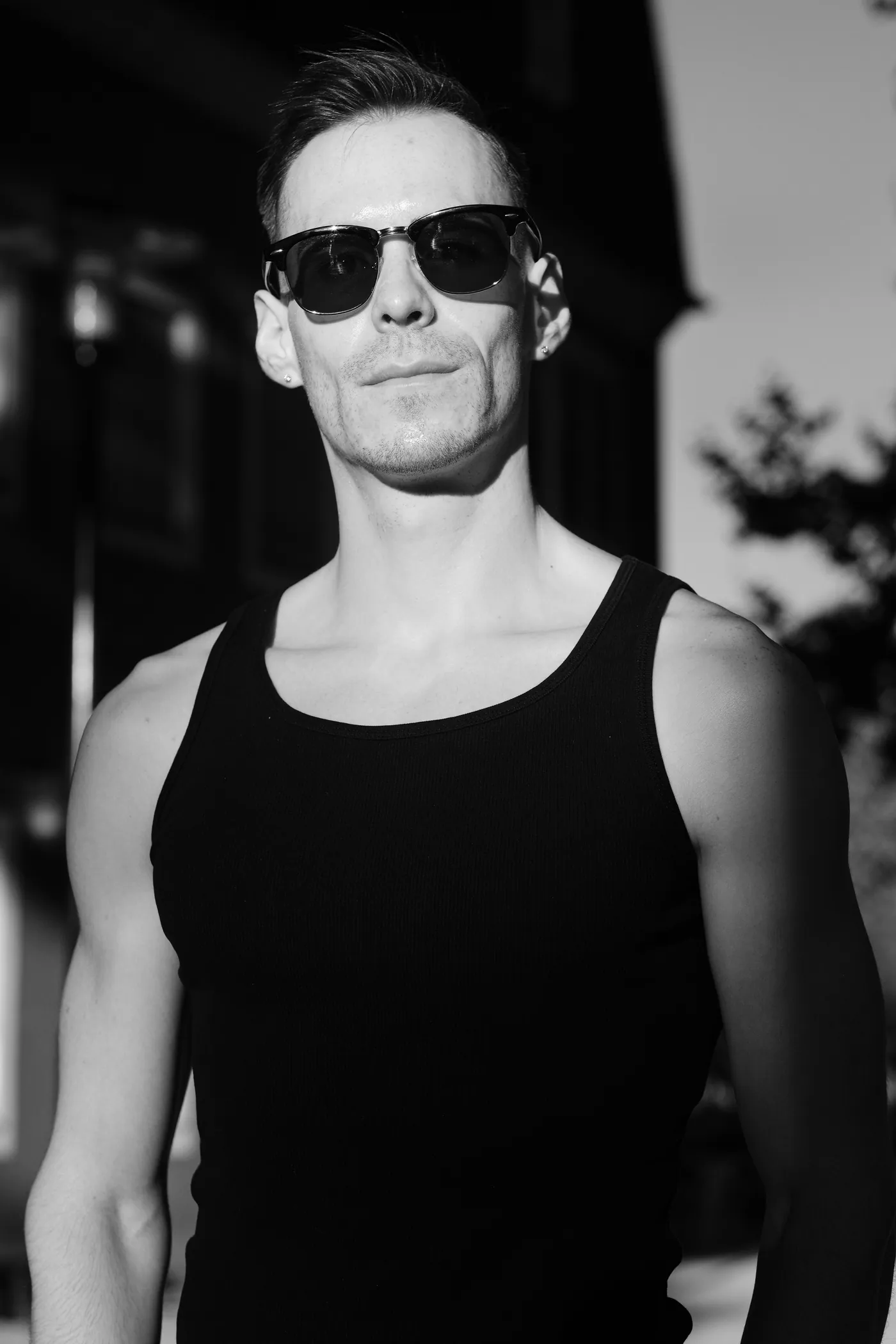 István in sunglasses, arms crossed, black and white portrait