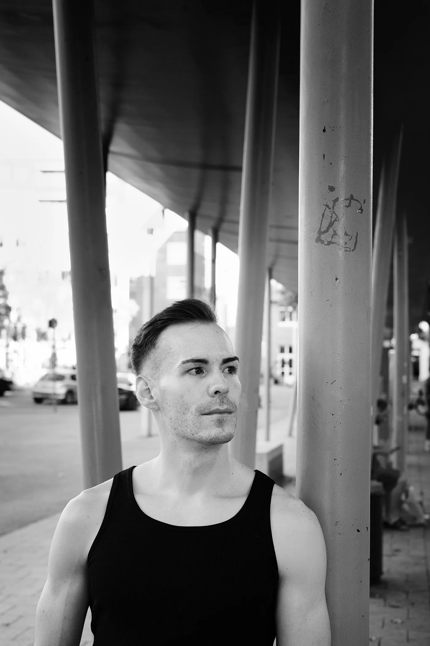 István in profile against an urban backdrop, black and white