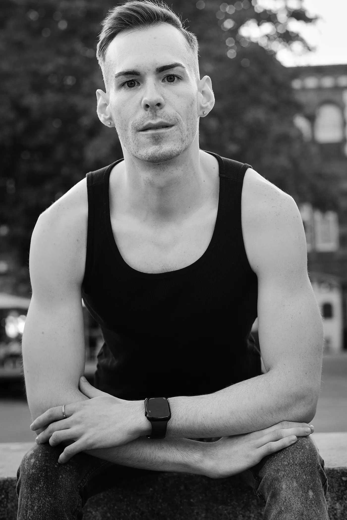 István seated with arms crossed, black and white portrait