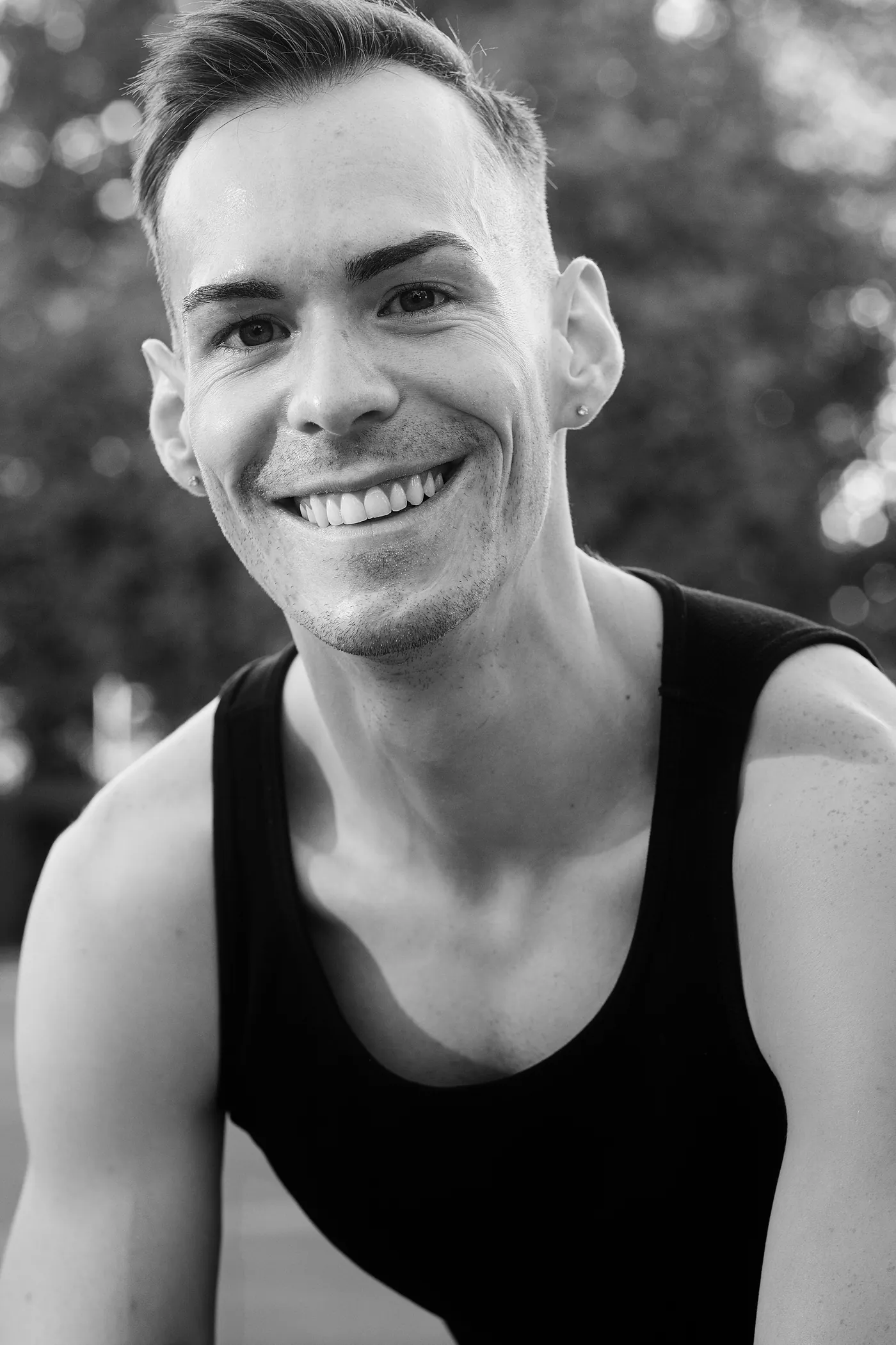 István seated and smiling, black and white portrait
