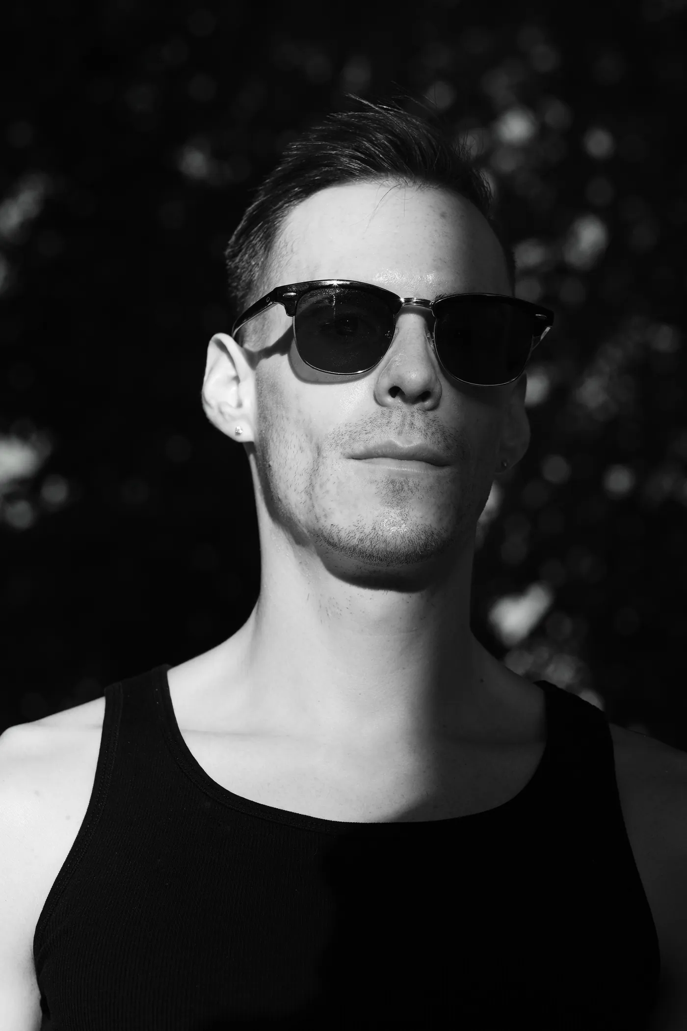 István in sunglasses under dramatic side lighting