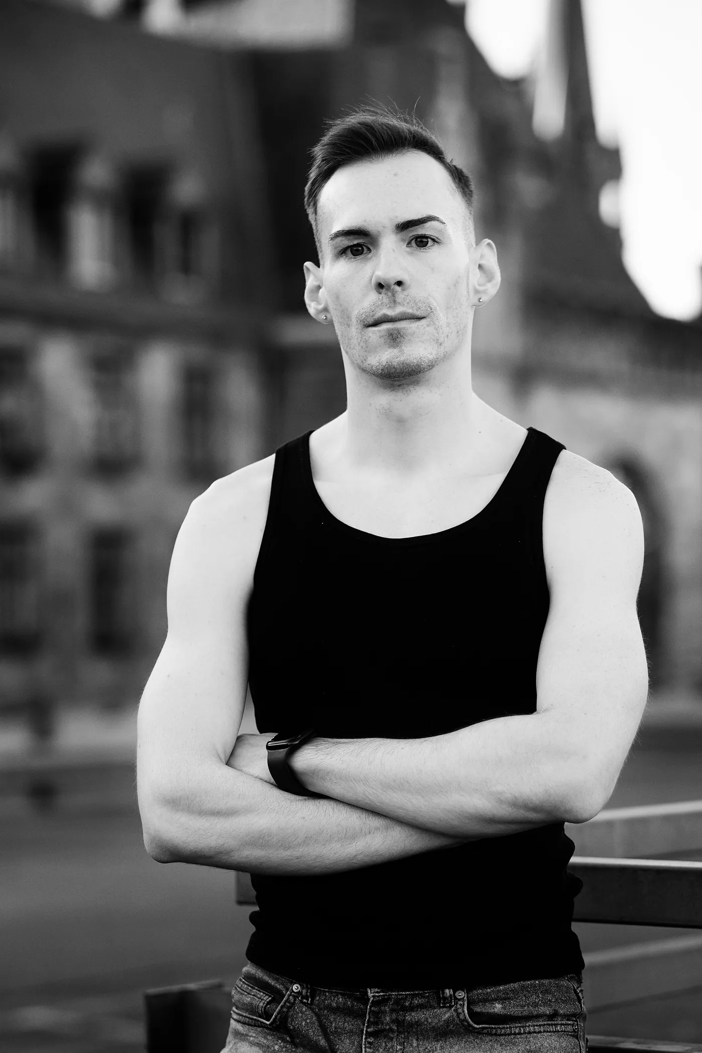 István standing with arms crossed, black and white portrait