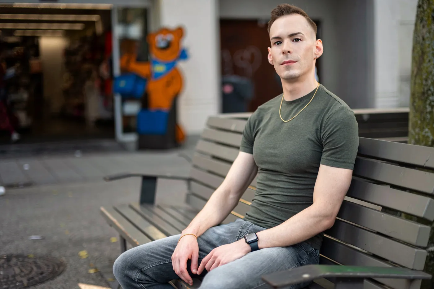 István sitting on a bench in a European old town